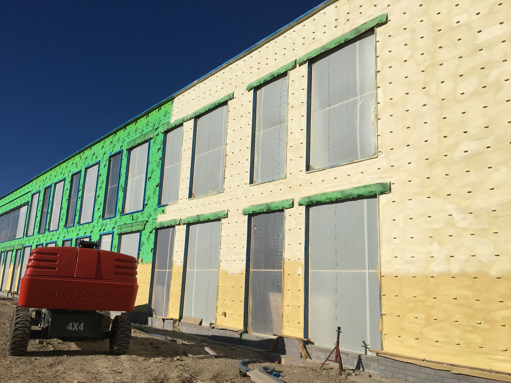 interior of large storage building with spray foam insulation on the walls 