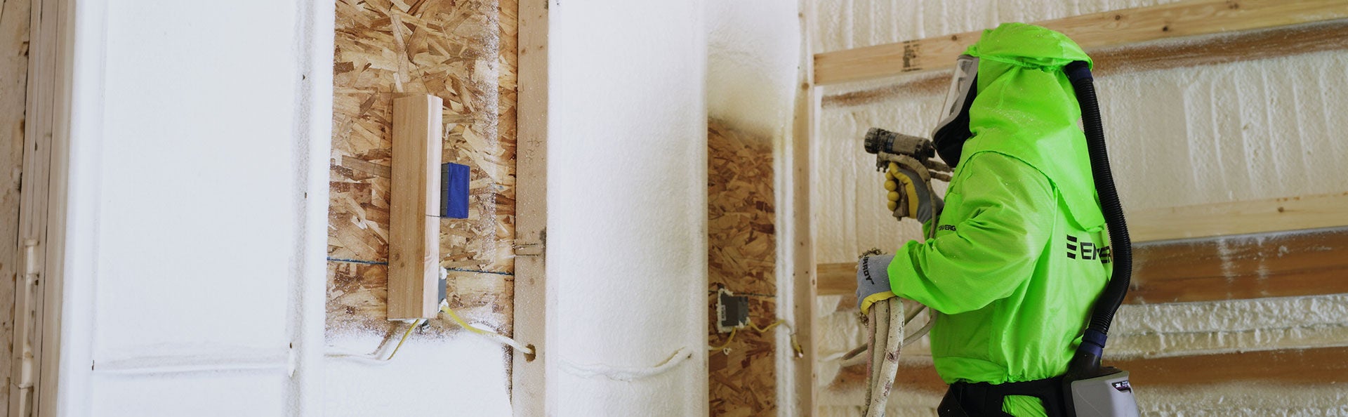 man spraying Enverge NEXSEAL insulation into wall